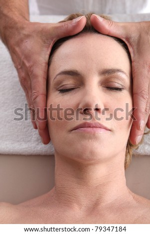 Woman being given a head massage.
