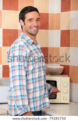 Man heating food in microwave