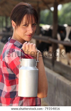 Farm worker holding milk container