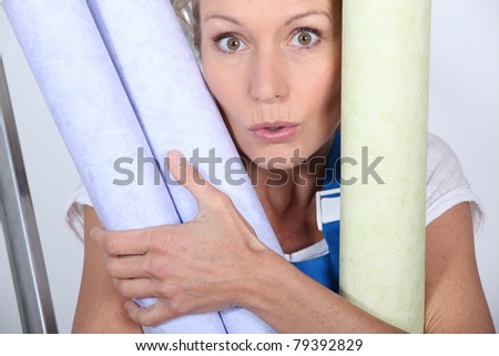 Closeup of woman with rolls of wallpaper