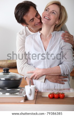 Happy couple cooking together at home