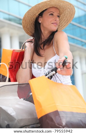 Woman on a bicycle with store bags