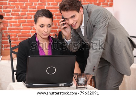 Young couple using a laptop computer in a restaurant