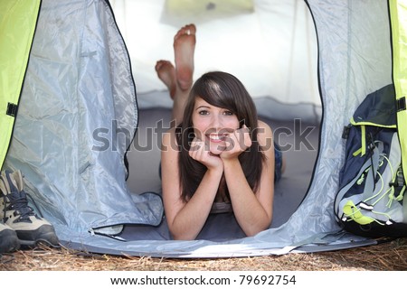 girl resting in a canvas tent