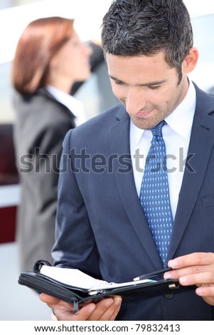 Man looking at his personal organizer