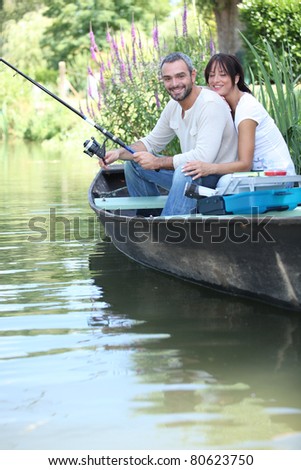 Couple fishing in a boat on a river