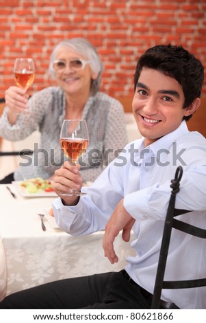 Young man having dinner with his grandmother
