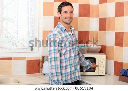 stock-photo-man-using-the-microwave-80613184.jpg