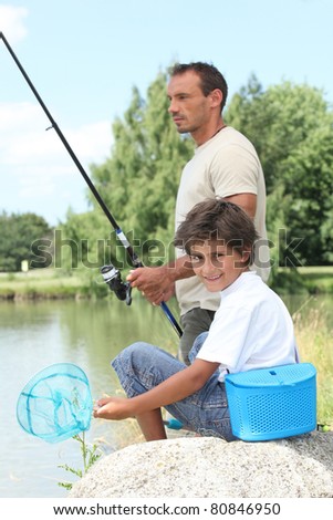Father and son fishing at a lake