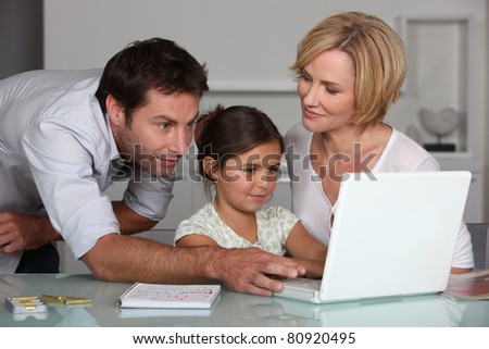 Parents and child looking at computer screen