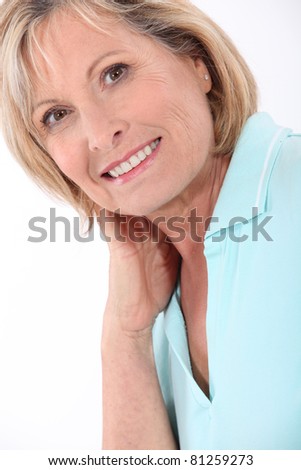 stock photo mature blonde woman wearing a turquoise polo shirt having a