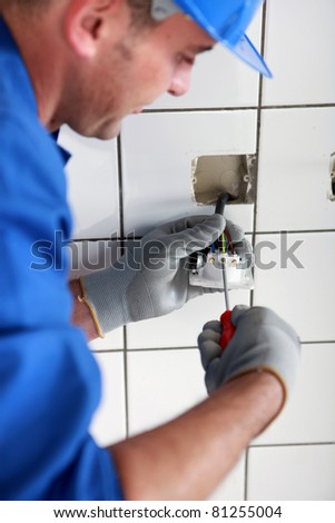 Man fitting an electric socket