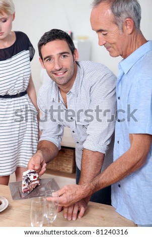 Man giving a slice of cake to his father