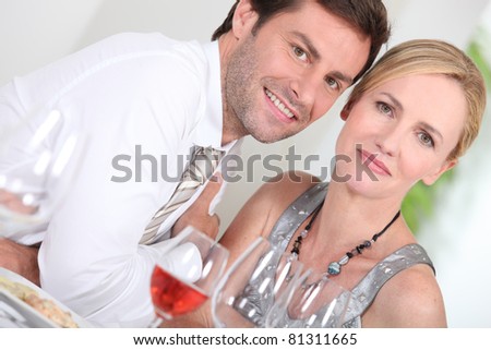 Couple drinking rose wine at a dinner party