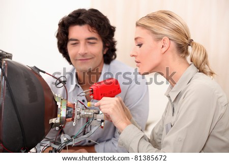 Woman repairing television
