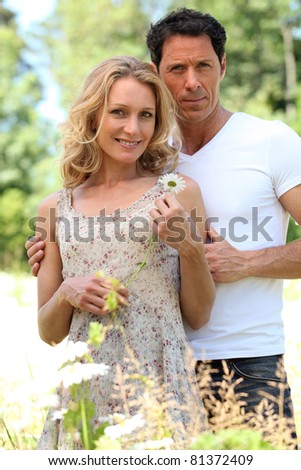 Husband with arm around wife.