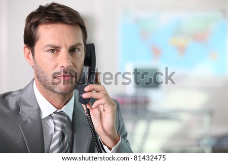 Businessman on the telephone with serious expression on face