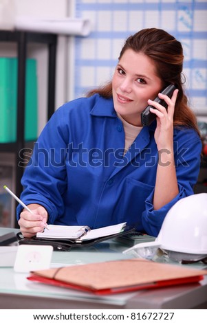 woman answering the phone in a office