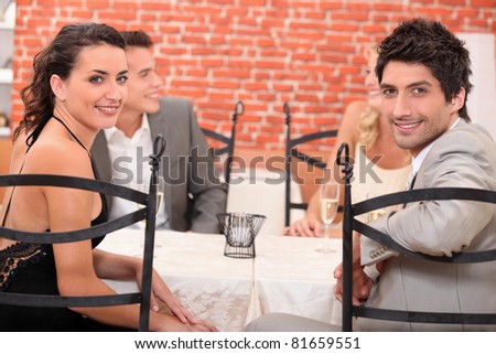 Two couples dining out in a restaurant