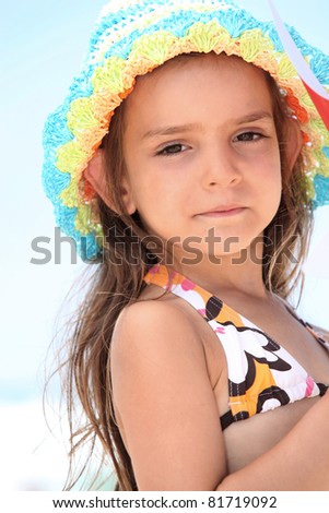 stock photo Young girl in a bikini and sunhat