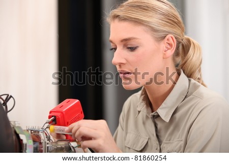 female technician working on an electronic circuit