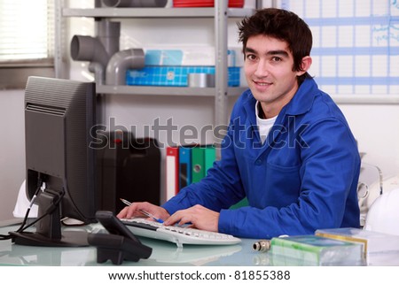 Plumber typing at a computer