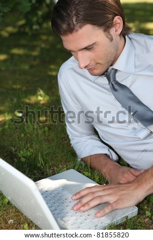 Businessman working outside on laptop