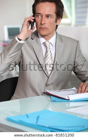 Serious executive taking call on cellphone