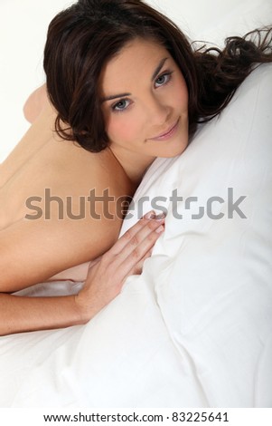 Portrait of a nude woman lying on a mattress