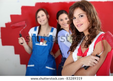 trio of handygirls painting room red