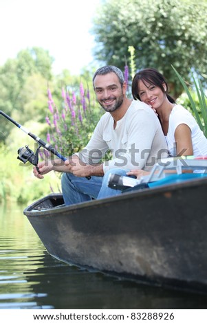 Couple fishing in a boat on a lake
