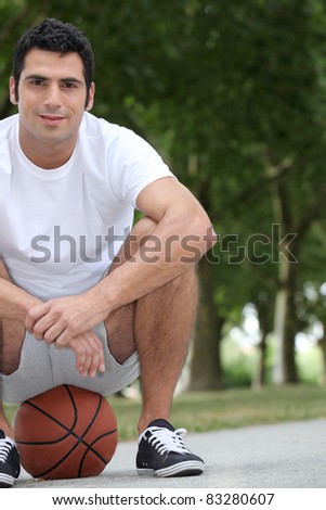 Man crouching on basketball