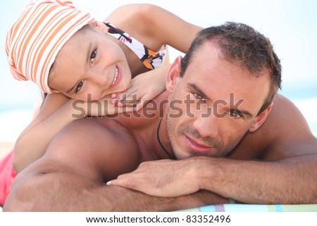Daddy and his daughter on the beach
