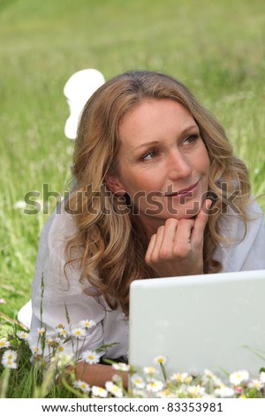 Woman on laptop in field