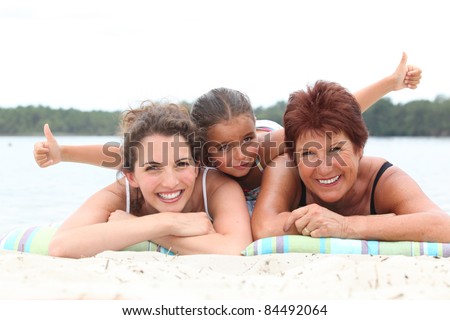 Three generations - grandmother, mother and daughter - on the beach