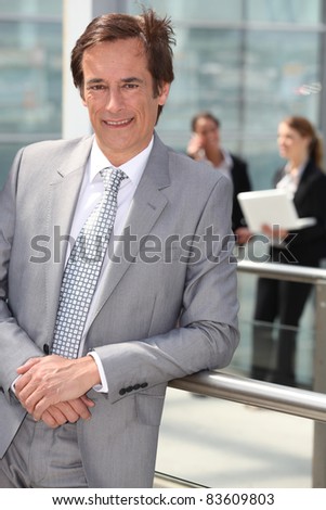 Smiling executive outside office building