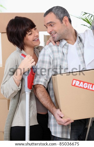 Couple moving into new home with boxes marked fragile