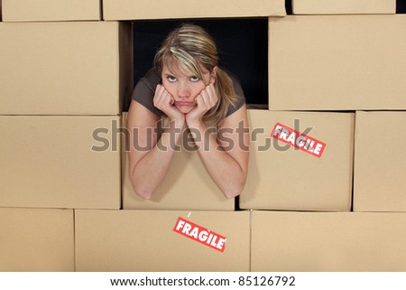 Bored woman surrounded by boxes