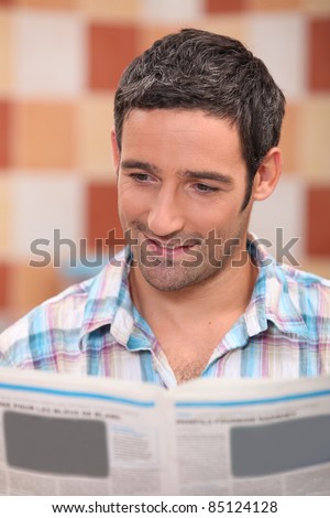 35 years old man reading newspaper