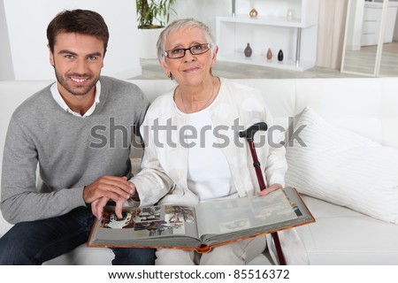 Elderly person looking at photos with son