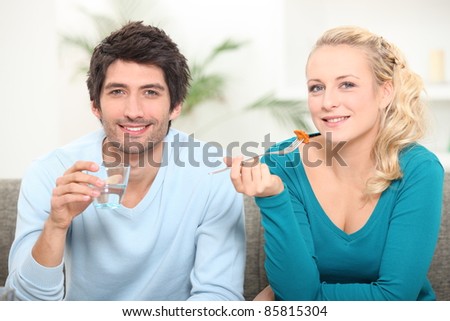 Couple eating lunch on the couch