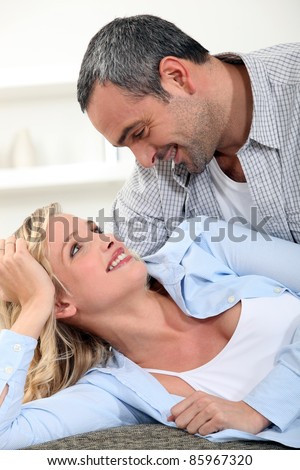 Romantic couple laying on couch