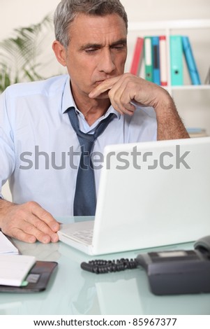 Grouchy man reading an email