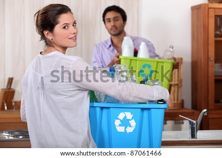 Man and woman preparing to recycle plastic bottles
