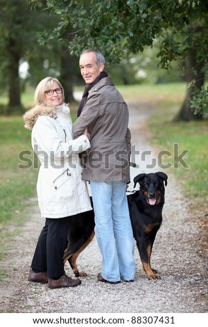 couple of pensioners walking their dog