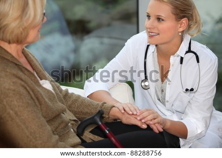 medical assistant taking care of senior woman