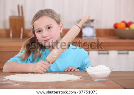 Little girl with rolling pin