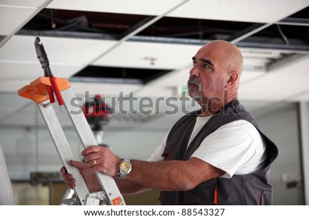 Man moving a ladder