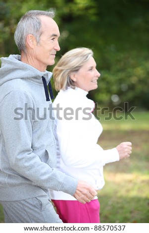 Happy senior couple jogging