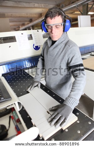 Man wearing ear defenders in a factory